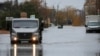 Грузовик едет по затопленной после шторма улице Евпатории, Крым, 27 ноября 2023 года