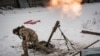 A Ukrainian soldier fires a mortar at Russian positions near Bakhmut.
