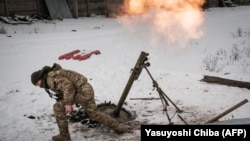A Ukrainian soldier fires a mortar at Russian positions near Bakhmut.