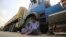 A driver sits beside his parked truck, carrying goods destined for Afghanistan, waiting for the opening of the border following clashes between the security forces of Pakistan and Afghanistan, in Torkham, Pakistan, on September 7.