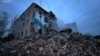 Rescuers search the rubble for survivors at the site of a residential building hit by a Russian missile strike in New York, Donetsk region, Ukraine, on January 14. 