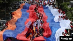 Armenia - People carry giant Armenian and Russian flags as they mark the 78th anniversary of Soviet victory over Nazi Germany, May 9, 2023.
