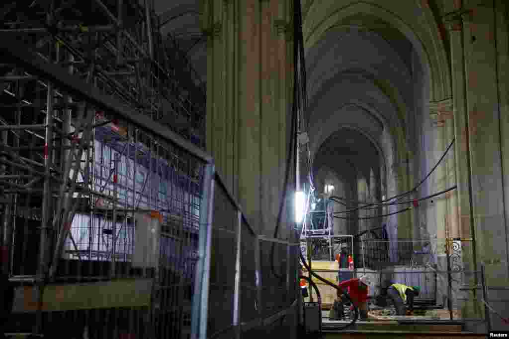 Punëtorët duke punuar në naos, pjesa qendrore e katedrales në formë kryqi e destinuar për të akomoduar pjesëmarrësit.&nbsp;Katedralja Notre Dame u shkatërrua nga zjarri në vitin 2019, që shkaktoi rrënimin e saj, ndërsa punimet për rindërtimin vazhdojnë një vit para rihapjes së saj për publikun, në Paris, Francë, 8 dhjetor 2023.