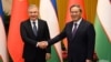 Uzbek President Shavkat Mirziyoev (left) meets Li Qiang, the premier of China's State Council in Beijing on January 23. 