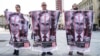 Великі плакати із зображенням російського президента Володимира Путіна за ґратами на акції проти війни в Україні. Італія, Турин, 20 серпня 2023 року (ілюстраційна світлина)