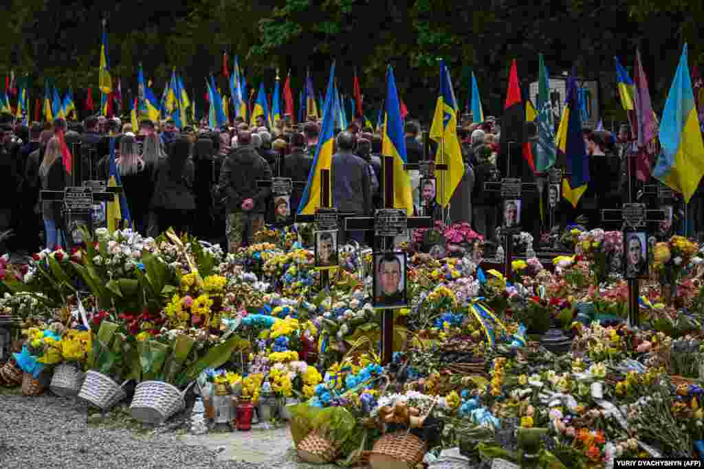 People attend the funeral of Ukrainian soldier Volodymyr Nestor, killed in combat with Russian troops, at a cemetery in Lviv.