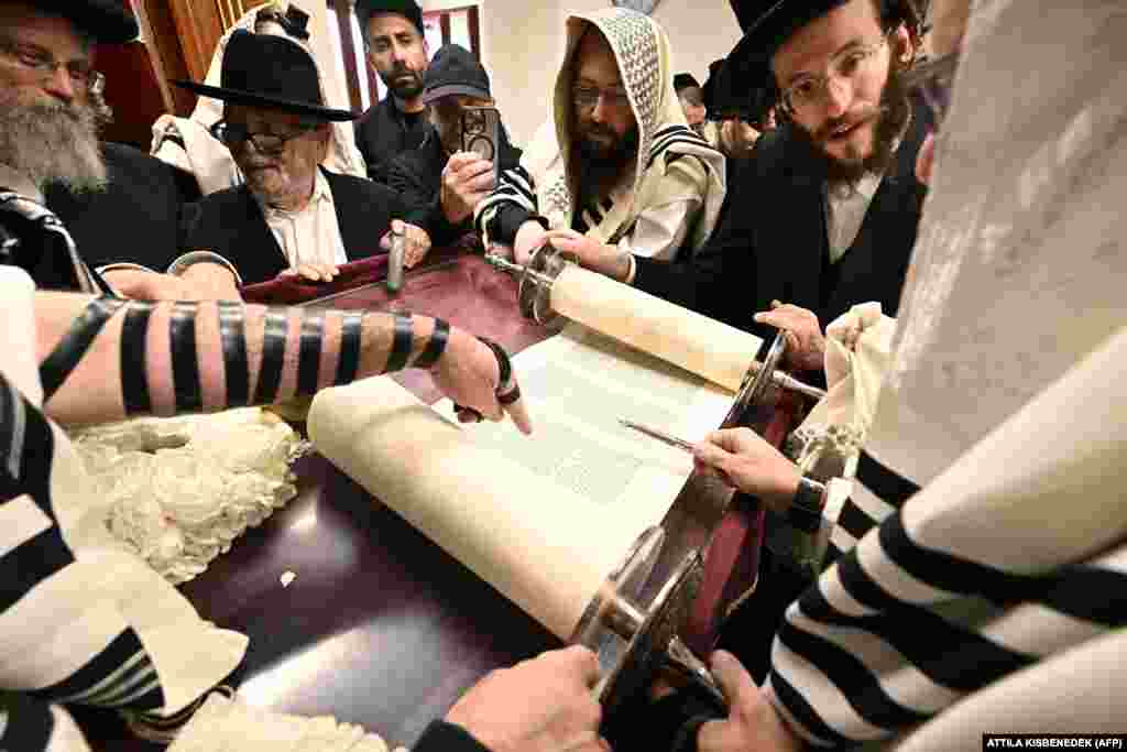 Hasidic Jewish pilgrims pray with the Torah in the former house of late miracle rabbi Yeshaya Steiner in the village of Bodrogkeresztur, Hungary.