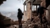 Local resident Tetyana inspects her ruined apartment at the site of a drone attack on a residential building in Kyiv on December 22, 2023.