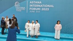 Visitors pose for photographs ahead of this year's Astana International Forum in Kazakhstan. 