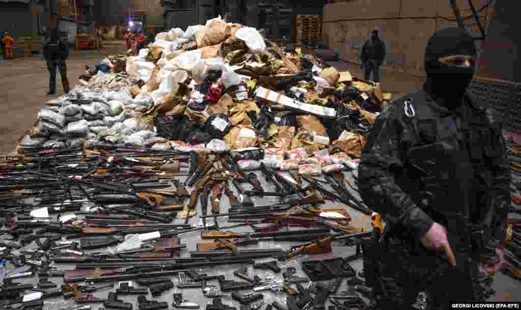 Members of the special police forces of North Macedonia prepare different types of drugs and weapons for destruction at the Makstil steel plant in Skopje. About 1,400 kilograms of drugs and 270 pieces of various illegal weapons confiscated in 2022 were destroyed.