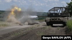 Ukrainian soldiers fire a test round from their T-72 tank at an undisclosed location in the Donetsk region. 