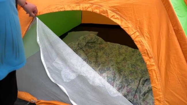 'It's Scary': Residents Of Shelled Kharkiv Buildings Sleep In Tents To Stay Safe
