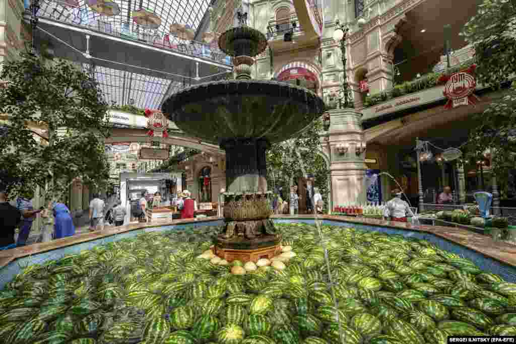 A fountain filled with watermelons and melons at the State Department Store GUM in Red Square in Moscow. Five tons of summer fruits were used to decorate the fountain to celebrate the beginning of the watermelon season in Russia.