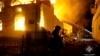 In this photo provided by the Ukrainian Emergency Service, firefighters work at the site of a burning building after a Russian drone attack in Dublyany on January 1.