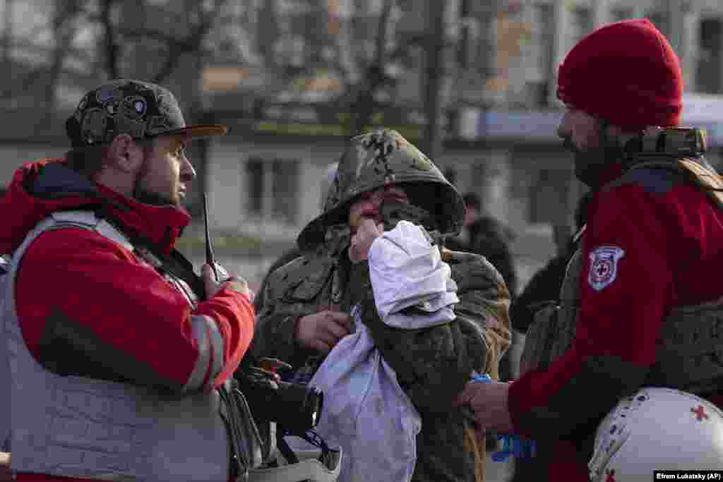 Paramedics attend to a woman who was injured during the morning missile attack in Kyiv. The attacks took place in several waves and from different directions, with Russia deploying strategic bombers to launch the missiles.