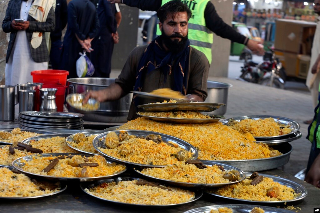 Vullnetarët përgatisin pjata ushqimore që u shpërndahen pastaj njerëzve gjatë Ramazanit, në një pikë të shpërndarjes së shujtave falas, në Peshavar, Pakistan, 16 mars 2024.