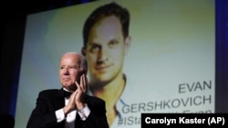 U.S. President Joe Biden appears in front of an image of jailed Wall Street Journal reporter Evan Gershkovich at an event in Washington in April.