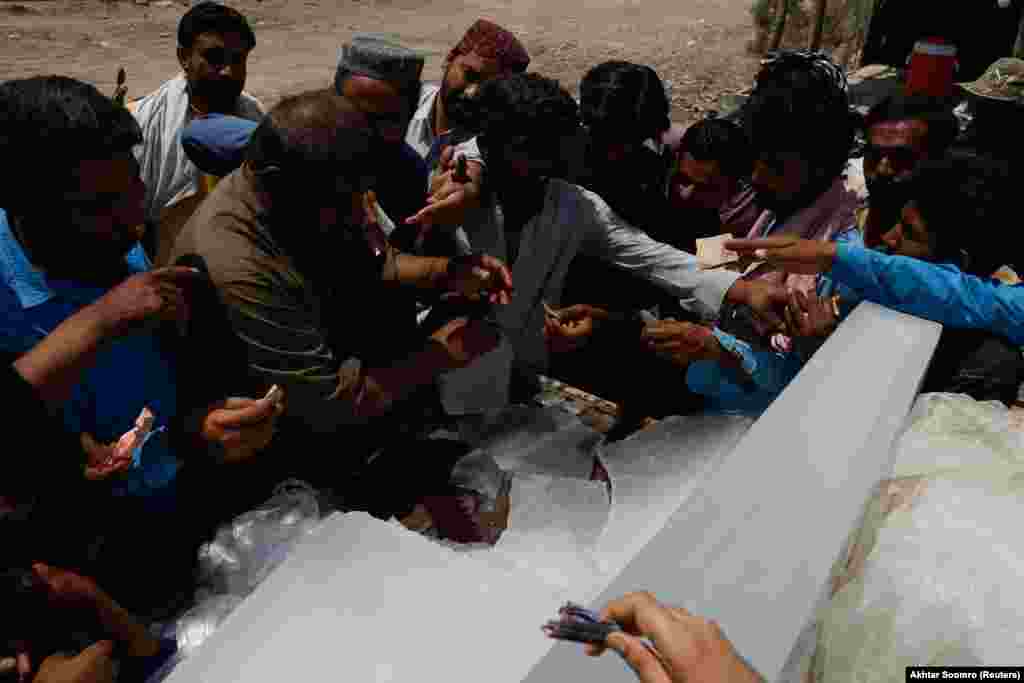 Ljudi kupuju blokove leda od prodavca u Džakobabadu, gde je temperatura dostigla 52 stepena Celzijusa. Mohendžoj Daro i Larkana bila su najtoplija mesta u Pakistanu pošto su temperature dostigle vrhunac od 53 stepena.