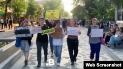 Members of Feminita march in Almaty, demanding a life sentence for former Economy Minister Quandyq Bishimbaev, on May 13.