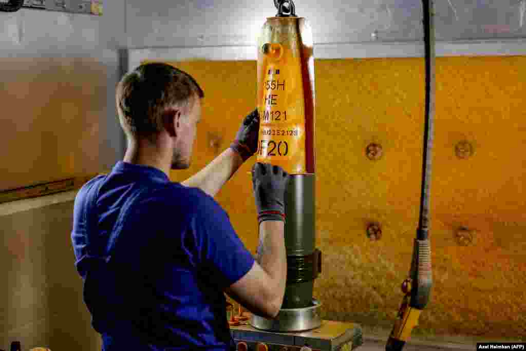 A Rheinmetall worker works on a heavy caliber shell.&nbsp; &nbsp;