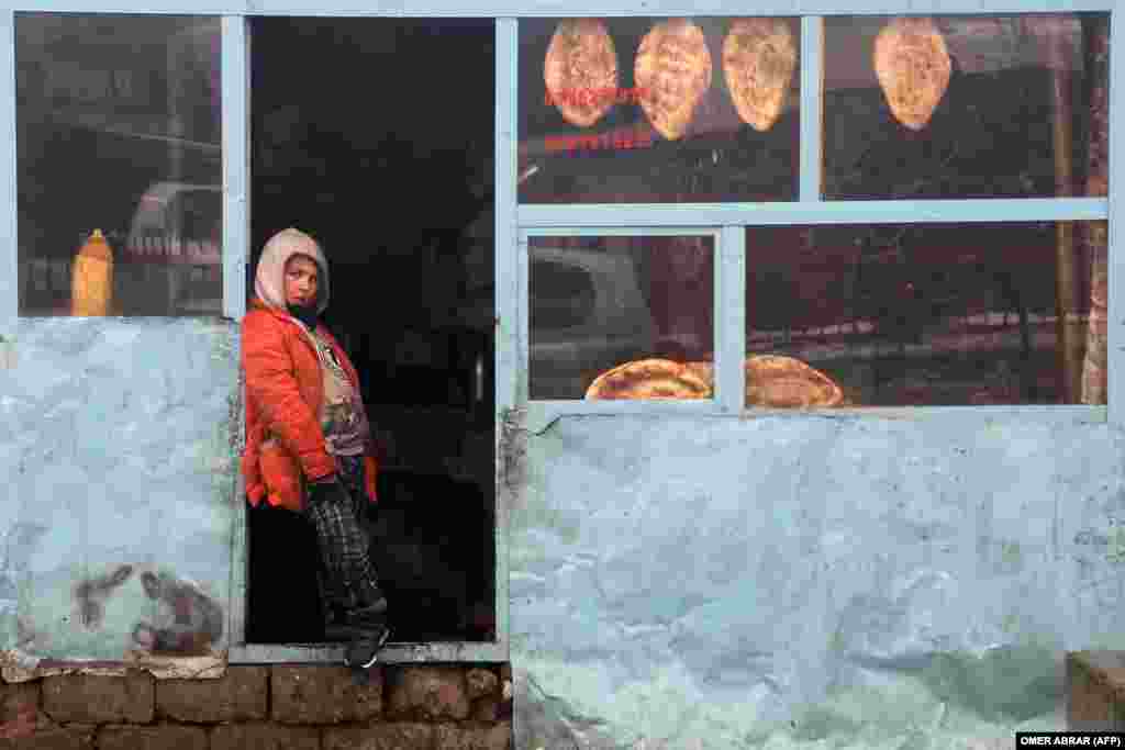 Një djalë afgan duke qëndruar në derën e një dyqani buke në distriktin Fayzabad të provincës Badakhshan.