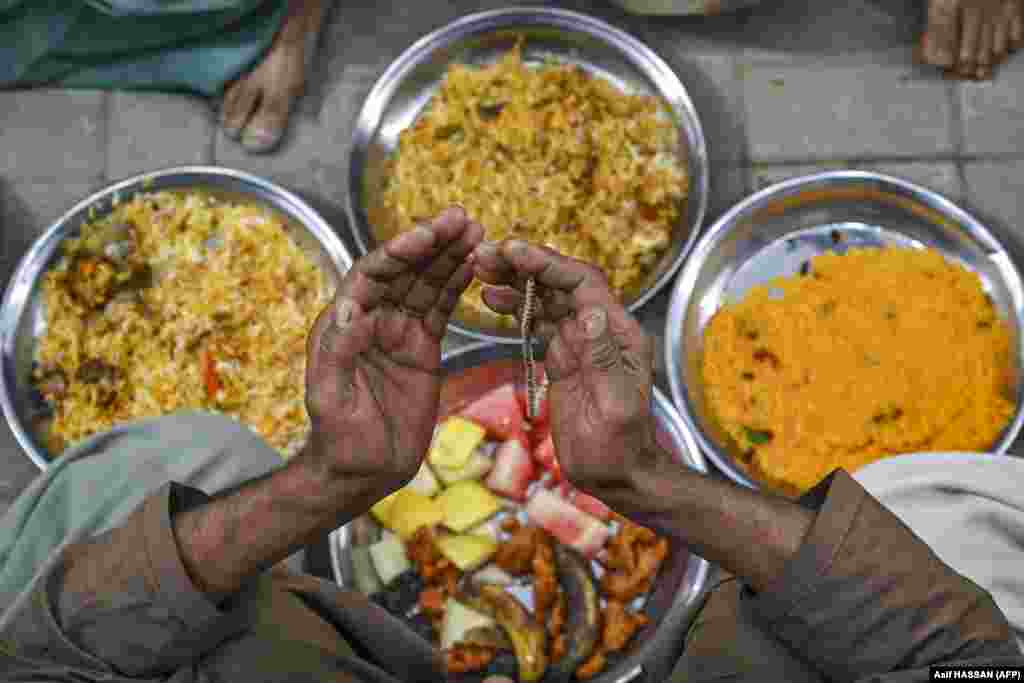 A Muslim devotee offers prayers before breaking his fast during the Islamic holy month of Ramadan in Karachi, Pakistan.