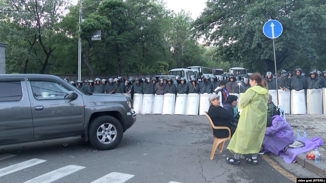 Anti-government protesters gather on a main road in downtown Yerevan where police were guarding access to Armenia's parliament on June 10.