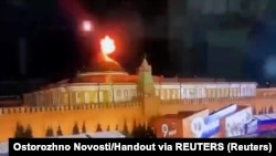A still image taken from a video shows a flying object exploding in an intense burst of light near the dome of the Kremlin Senate building during an apparent drone attack in Moscow on May 3.