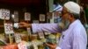 A customer buys rice at a wholesale shop in Karachi.