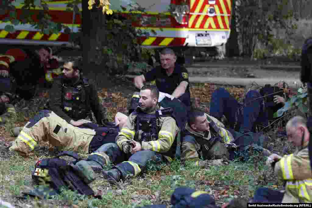 Ukrainian emergency workers rest in the wake of a deadly Russian missile attack on a supermarket in Kostyantynivka on August 9.&nbsp;