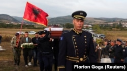 Police officers carry the coffin during a funeral for a colleague killed in the Kosovo shoot-out, near Vushtrri, Kosovo, on September 25.
