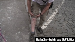 Davit Tamazashvili shows what he says is wound from rubber bullet fired by police in Tbilisi on May 1.