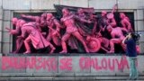 Bulgaria -- A cameraman films the figures of Soviet soldiers at the base of the Soviet Army monument 