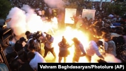 Armenia - A police stun grenade explodes during a rally against Prime Minister Nikol Pashinian in Yerevan, June 12, 2024. (Vahram Baghdasaryan/Photolur via AP)