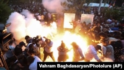 Armenia - A police stun grenade explodes during a rally against Prime Minister Nikol Pashinian in Yerevan, June 12, 2024.