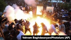 Armenia - A stun grenade fired by police explodes during an antigovernment protest in Yerevan, June 12, 2024.