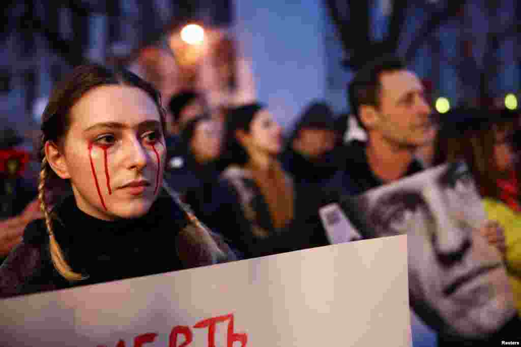 A woman attends a vigil held in front of the Russian Embassy in Berlin after the death of Russian opposition leader Aleksei Navalny on February 16.