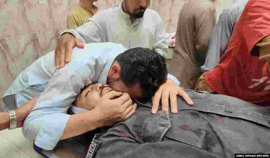 Relatives mourn over the body of one of the guards killed after unidentified gunmen shot two police officers deployed to protect a polio vaccination team, in Quetta. Pakistan is one of three remaining polio-endemic countries in the world, along with Afghanistan and Nigeria.