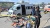 Police stand guard at the scene of the attack in Karachi on April 19.