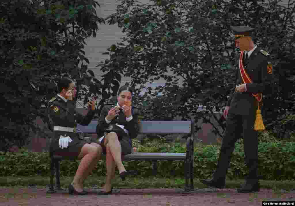 Ukrainian servicewomen put on makeup before a graduation ceremony in Kyiv for officers from Ukraine&#39;s Territorial Defense forces.