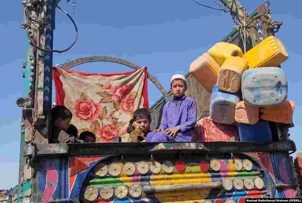 Young boys sit atop a truck that will carry them across the border at Chaman. Since ousting the Western-backed Afghan government and taking over the country in August 2021, the Taliban has placed restrictions on women&#39;s appearance, freedom of movement, right to work and study, and access to society.&nbsp;Restrictions have also been placed on the media, activists, and civil society organizations.