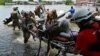 Ukrainian soldiers help unload a local resident from a boat during an evacuation from a flooded area in Kherson. Authorities said that several thousand people were evacuated despite&nbsp;<a href="https://www.rferl.org/a/kherson-residents-shelling-flooding-ukraine-dam-russia/32450738.html" target="_self">Russian shelling</a> from across the Dnieper River.