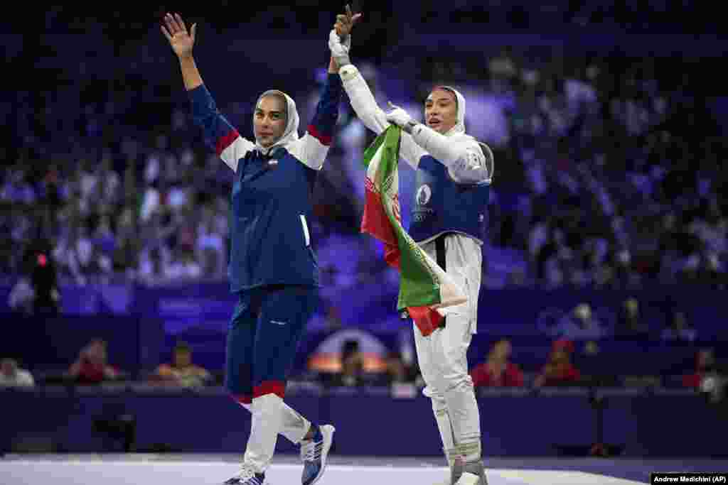 Iran&#39;s Mobina Nematzadeh (right) celebrates with Iranian coach Mahruz Saei after winning the women&#39;s 49-kilogram&nbsp;taekwondo bronze-medal match against Saudi Arabia&#39;s Dunya Ali M Abutaleb on August 7.