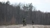 Belarusian border guards patrol along the frontier near the Divin border crossing point between Belarus and Ukraine in the Brest region on February 15, 2023. 