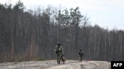 Belarusian border guards patrol along the frontier near the Divin border crossing point between Belarus and Ukraine in the Brest region on February 15, 2023. 