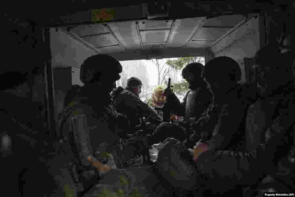 Ukrainian servicemen sit inside a van in Chasiv Yar. Of the two roads that connect Bakhmut to the outside world, one runs through Chasiv Yar. &nbsp;