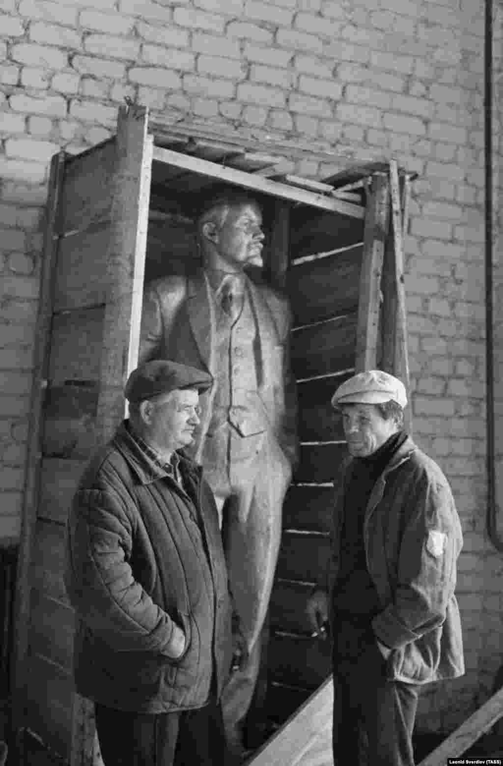 Workers near a boxed statue of Soviet founder Vladimir Lenin meant for display in Svyatsk, western Belarus, in September 1991. The newly delivered statue remained boxed, with the local authorities unsure what to do with the monument after Belarus won its independence from the Soviet Union one month before this photo was taken.