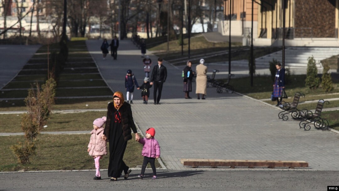 A woman with children walks in Nazran. Ingushetia