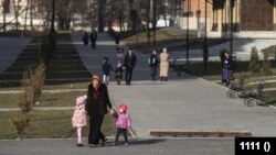 A woman with children walks in Nazran. Ingushetia