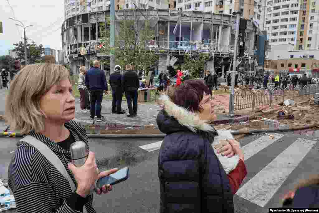 Residents watch as emergency crews work at the scene.